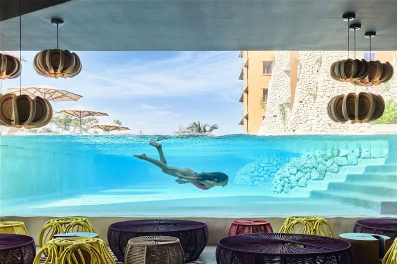 woman swimming in pool at xcaret arte