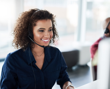 smiling woman on the phone at call center acting as travel concierge